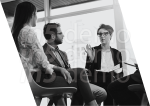 Three people sitting in chairs. Description generated by AI